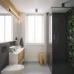 Prysznic z przeszklonymi drzwiami i dekoracyjną tapetą